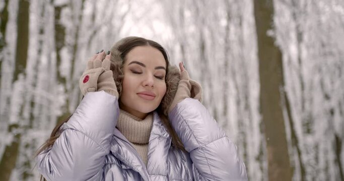 Girl wearing fir ear muffs and cute gloves