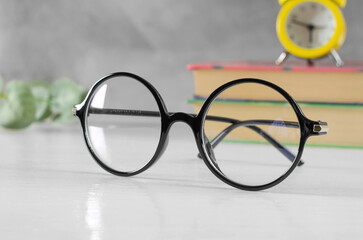 Stylish glasses for vision in a black round frame on the table