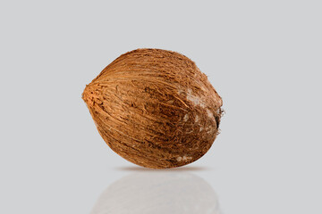 full coconut isolated on a grey background.