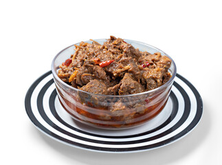Traditional Beef Curry Served in transparent bowl front view on ceramic plate