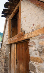 Fototapeta na wymiar a traditional wooden door at the entrance to a Spanish stone dwelling, Pyrenees mountains, Spain