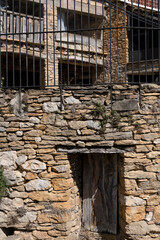 old Spanish beige stone village property in summer sunshine