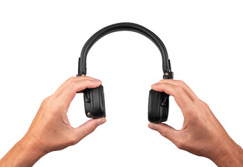 Hands holding black headphoones closeup, isolated on white background