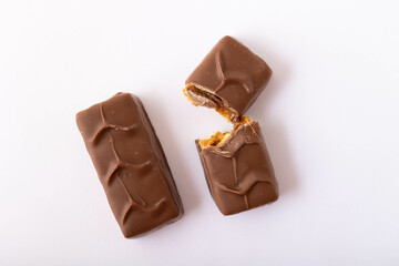 Chocolate bar on a white background. Chocolate bar broken in half.