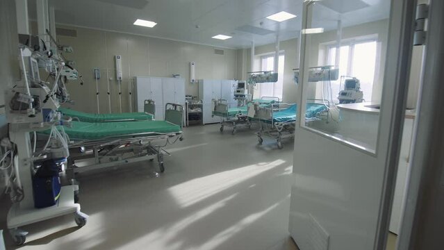 Empty intensive care ward with beds and modern equipment in medical center. Professional patient service providing