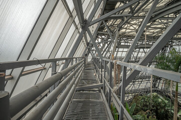 Engineering metal structures of the frame of the greenhouse, view from the technological bridge.