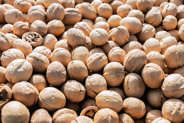 Background from walnuts. Sale of walnuts at the farmers' market. The high content of vitamins and microelements in walnuts nourishes the body and restores strength, and also improves immunity.