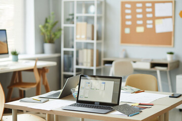 Background image of open laptop on workplace desk in creative office interior, copy space
