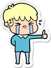 sticker of a cartoon boy crying