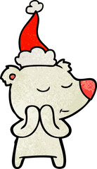 happy hand drawn textured cartoon of a polar bear wearing santa hat
