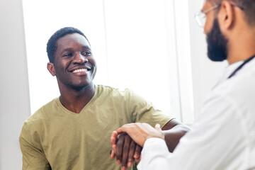 doctor and male patient talking at office consultation for further treatment