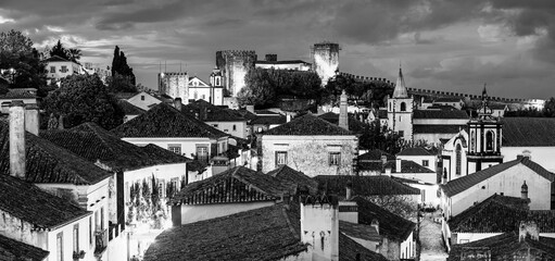 Evening skyline of Obidos village in Portugal; Twilight cityscape of medieval village for holiday destination