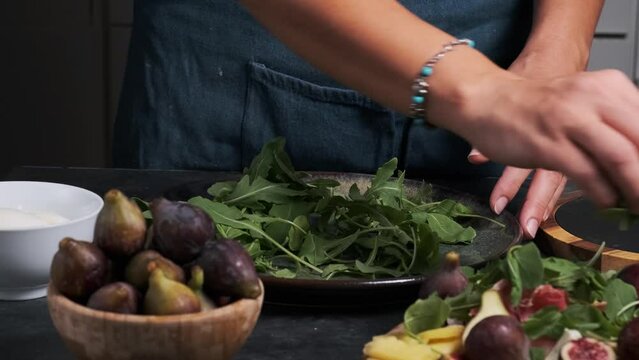 women's hands make fresh salad