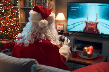 Funny Santa Claus playing video games at home
