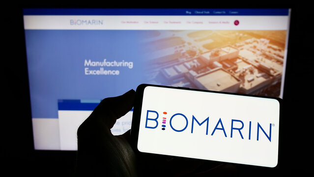 Stuttgart, Germany - 10-02-2022: Person holding cellphone with logo of US company BioMarin Pharmaceutical Inc. on screen in front of business webpage. Focus on phone display.