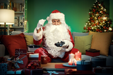 Happy Santa Claus playing video games at home