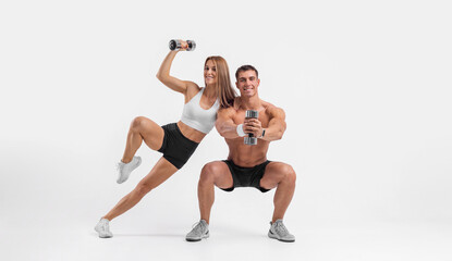 Fototapeta na wymiar Fit couple at the gym isolated on white background. Fitness concept. Healthy life style. Fitness-Related Materials for Your Social Media Marketing Campaigns