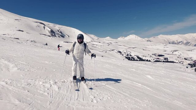 Athlete man with beard jumping excided before skiing in winter resort, slow motion