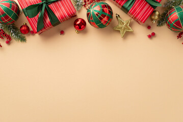 New Year concept. Top view photo of red present boxes with green ribbon bows baubles gold star ornament mistletoe berries and pine branches in snow on isolated beige background with empty space