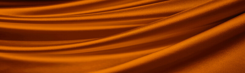 Dark orange brown silk satin. Drapery fabric. Curtain. Luxury background for design. Beautiful soft...
