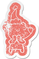 happy quirky cartoon distressed sticker of a polar bear wearing santa hat