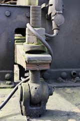Historic railway. Old steam locomotive. A part of the suspension - big screw.