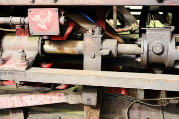 Historic railway. Old steam locomotive. A part of the suspension - pistons are visible.