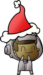 Naklejka premium happy hand drawn gradient cartoon of a astronaut wearing santa hat