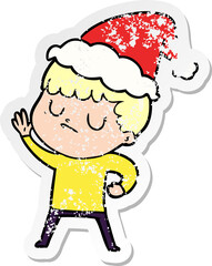 Obraz premium hand drawn distressed sticker cartoon of a grumpy boy wearing santa hat