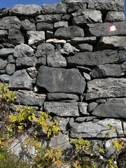hiking trail sign on a stone wall background