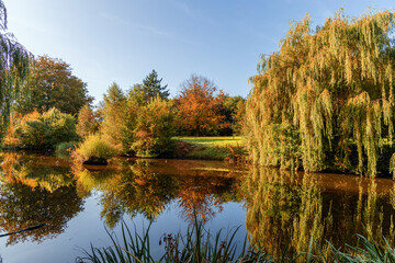 Beautiful colorful autumn lake surrounded by autumn follage. Autumn background.