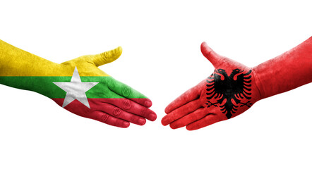 Handshake between Albania and Myanmar flags painted on hands, isolated transparent image.
