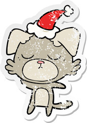 cute hand drawn distressed sticker cartoon of a dog wearing santa hat