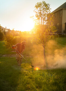 Landscaper Trimming Edge Of The Grass 