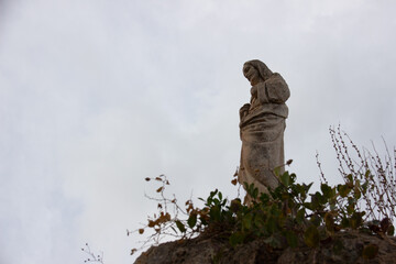 statue of a Christ in Mijas pueblo with mountains skyline in the background