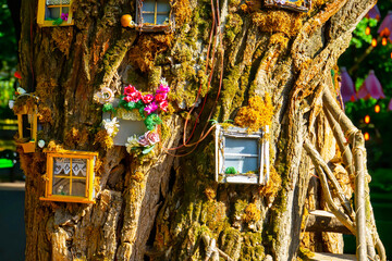 Fantasy fairy tale forest with magical shining window of enchanted elf or gnome house 