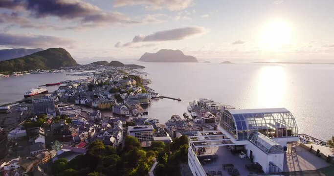 Bird's eye view of Alesund port town on the west coast of Norway, at the entrance to the Geirangerfjord. Colorful evening scene of the Nord. Traveling concept background.
