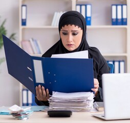 Female employee bookkeeper in hijab working in the office