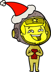 hand drawn textured cartoon of a laughing astronaut wearing santa hat