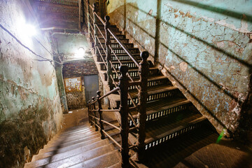 Old forged iron staircase in shabby historical building
