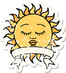worn old sticker with banner of a sun with face