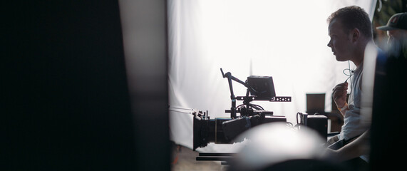 Director of photography with a camera in his hands on the set. Professional videographer at work on filming a movie