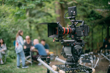 Professional cinema and video camera on the set. Shooting shift, lighting fixtures, shooting equipment and the team.