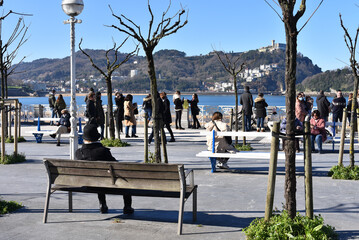 San Sebastian, Spain - 22 Jan, 2022: Winter along La Concha Bay & the beachfront promenade © Mark