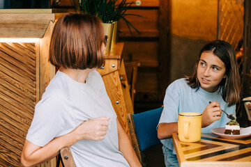 mother and daughter spend time together in a cafe