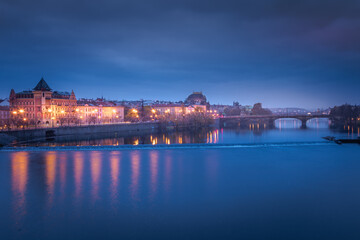 Fototapeta na wymiar Prague old town and Vltava river illuminated at peaceful dawn, Czech Republic