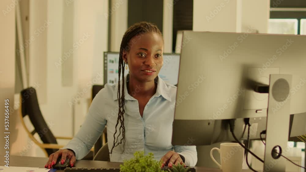 Poster startup employee working on computer in office with big windows, using data research to create busin