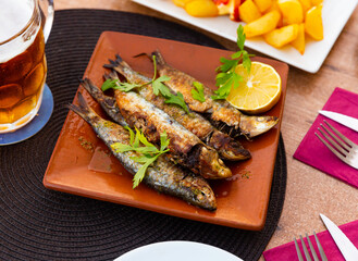Fried sardines with lemon and parsley clodeup