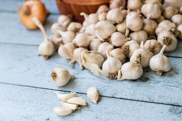 Fresh raw whole garlic and onions on wooden background
