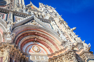 Medieval ancient and ornate cathedral at clear sky, Tuscany, Italy
